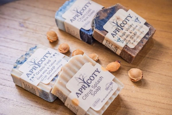 Apricoty handmade soap bars wrapped in branded paper packaging
